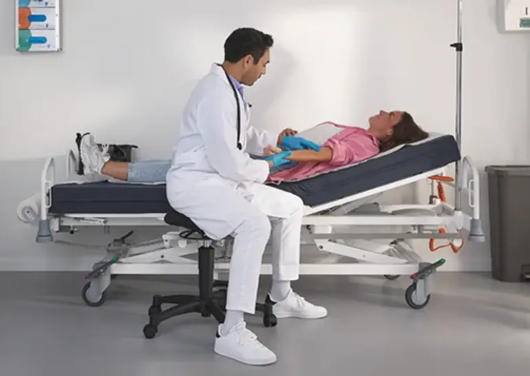 Evario one hospital bed shown without safety sides for unobstructed patient access and flexible care.