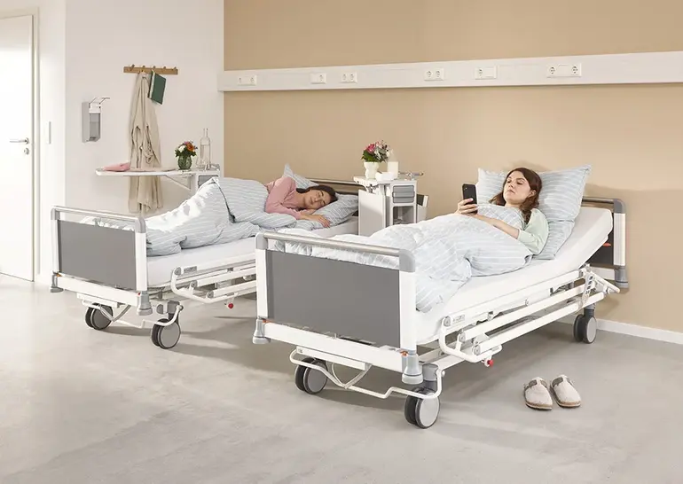 Evario one hospital bed featuring pivoting 3/4 safety sides for ergonomic operation and patient safety.