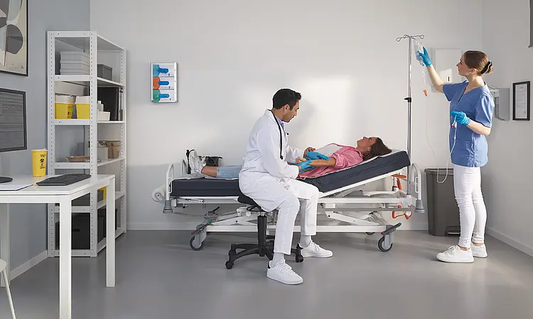 Modern Evario one hospital bed in an outpatient treatment room at a healthcare centre.