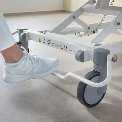 Caregiver pushes Evario one hospital bed down the hospital corridor