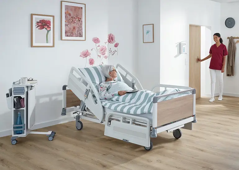 Evario one Krankenhausbett mit einer 50 / 50 Sicherheitsseiten. Die Seitensicherung ist auf der Länge des Bettes geteilt in der Mitte.