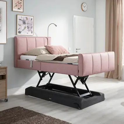 La cama Libra - variante deluxe incluye de serie un elegante somier con funda de fieltro moldeado y chasis barnizado en negro.