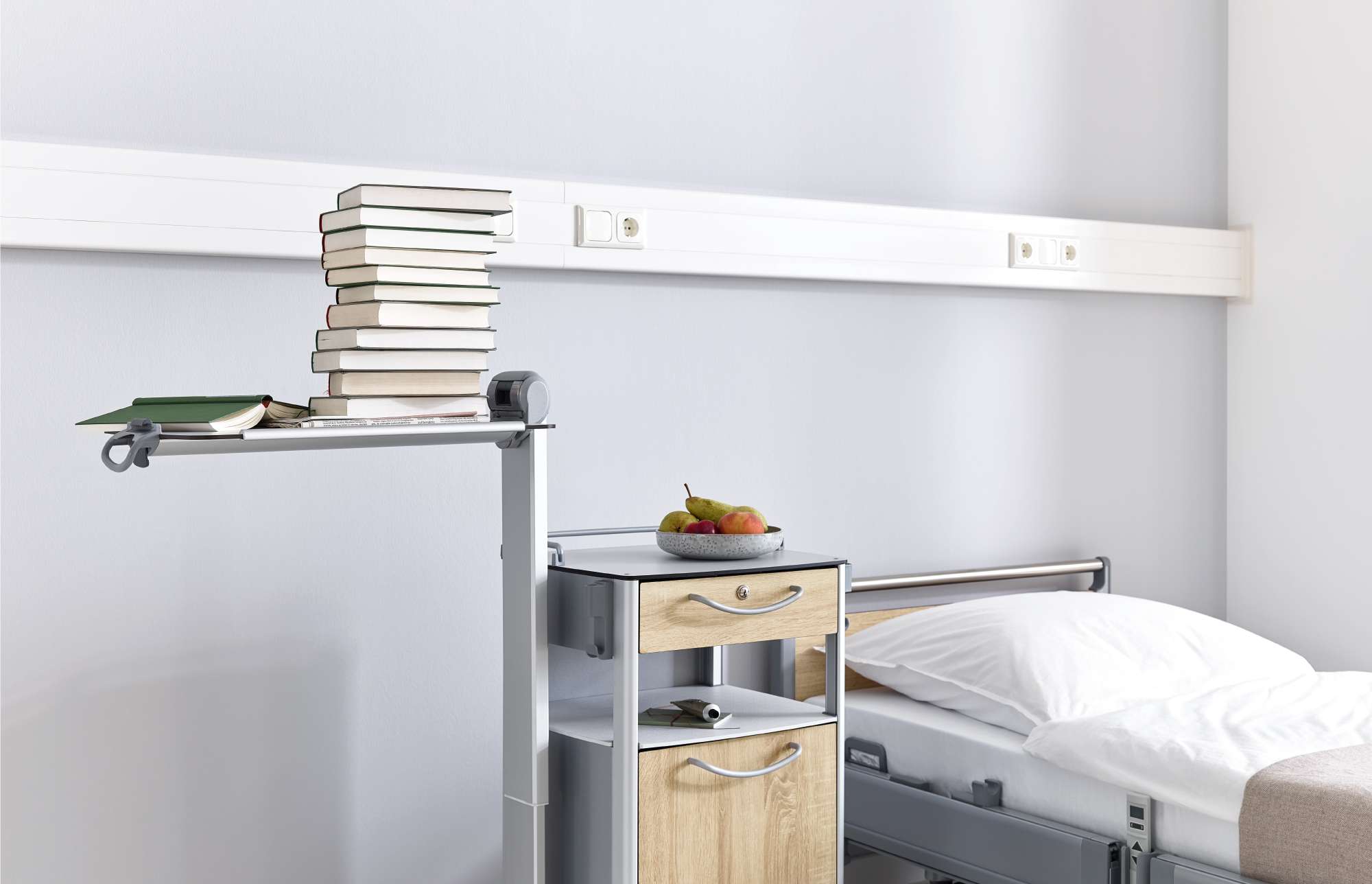 Height-adjustable overbed table on the Vitano bedside cabinet